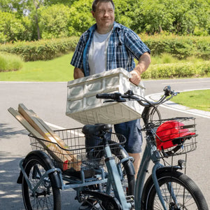 Man loading cargo into the Aitour Heal Middle Electric Trike 250W, showcasing its large front and rear baskets for carrying goods.
