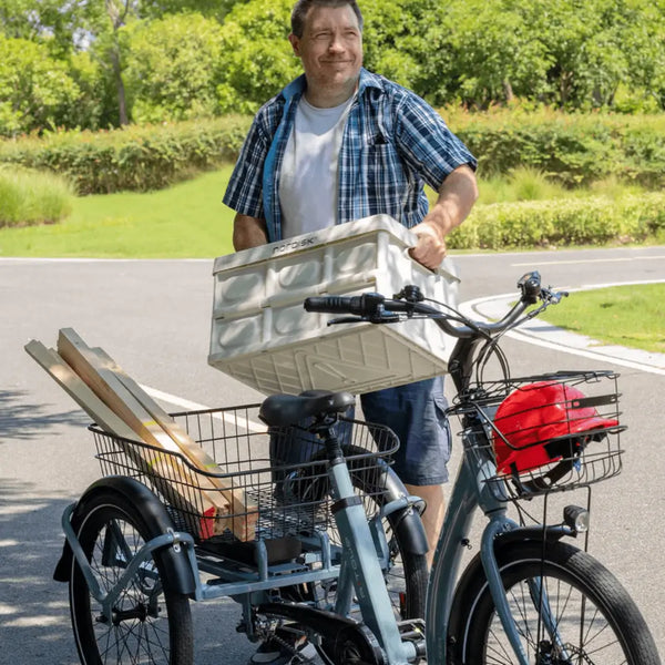 Man loading cargo into the Aitour Heal Middle Electric Trike 250W, showcasing its large front and rear baskets for carrying goods.