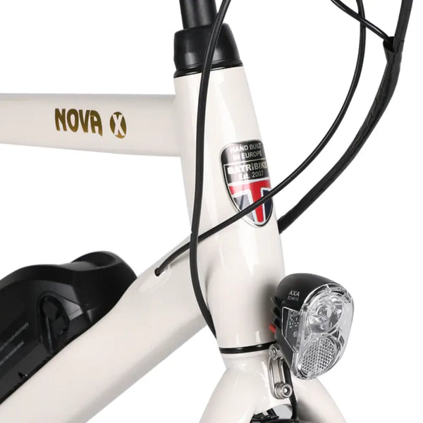 Close-up of the Batribike Nova X electric bike head tube with AXA front light and brand badge.
