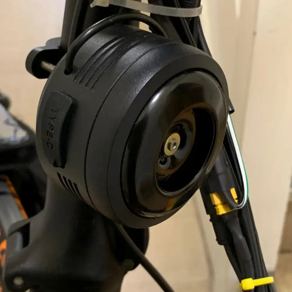 Close-up of Big Game Bikes 125dB electric bike horn showing USB-C charging port.