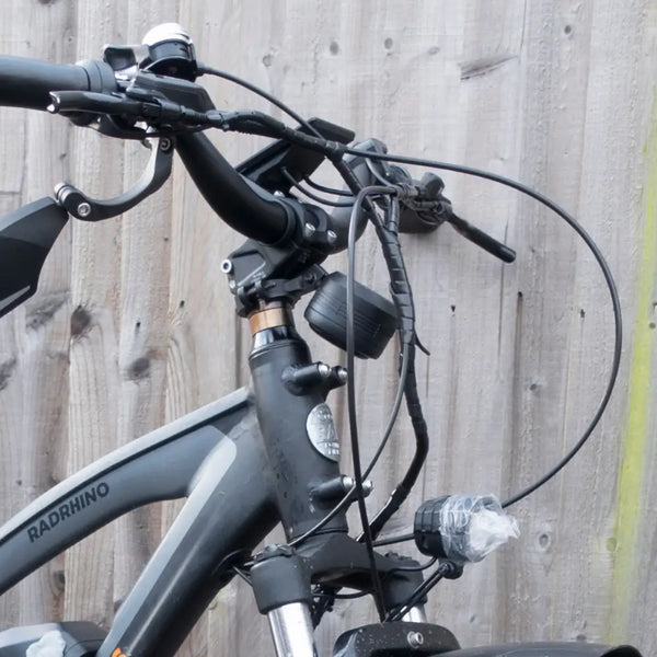 Side view of Big Game Bikes 125dB electric bike horn installed on bicycle handlebars.