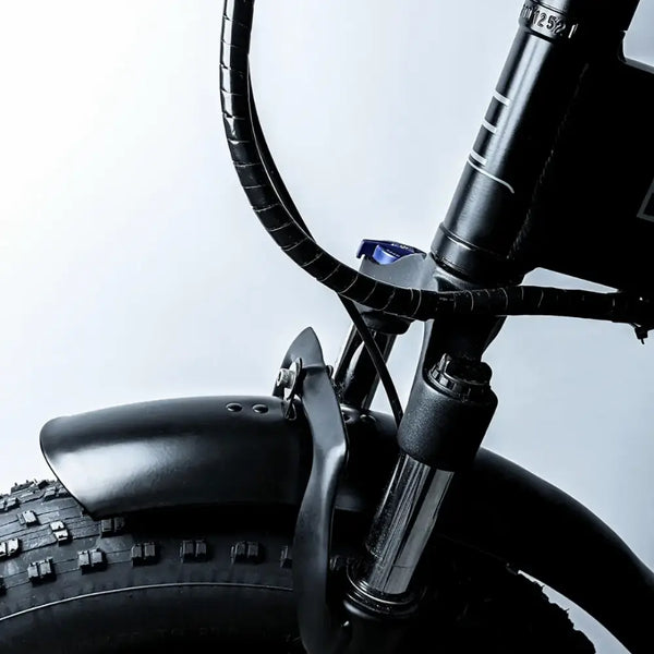 Close-up of the front suspension fork and large fat tyre on the EMovement Panther V4.2.