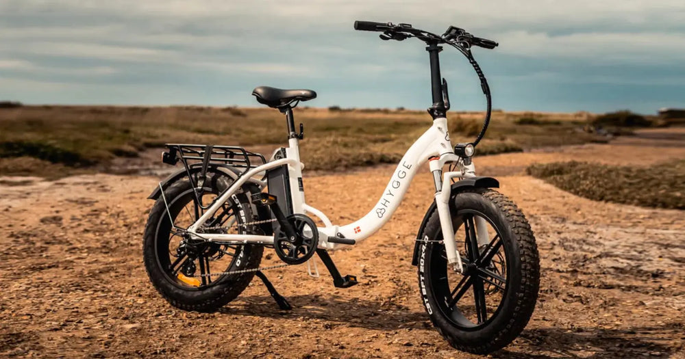White Hygge Vester folding electric bike with fat tyres and step-through frame.