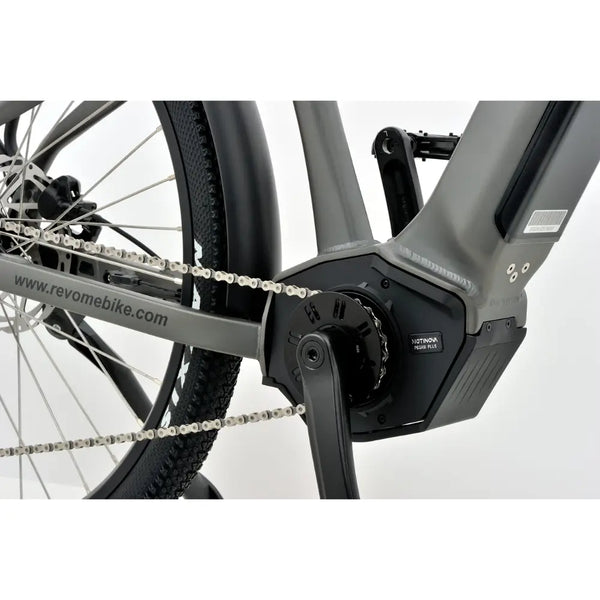 Close-up of the mid-drive electric motor and chain on the Revom S1 ATB bike.