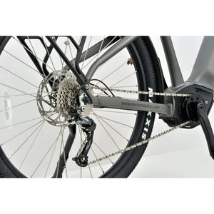 Close-up of the rear wheel, cassette, and derailleur on the Revom S1 electric bike.
