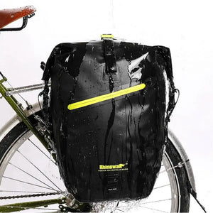 Waterproof rear rack pannier in black mounted on a bicycle.