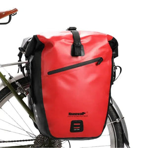 Waterproof rear rack pannier in red mounted on a bicycle.