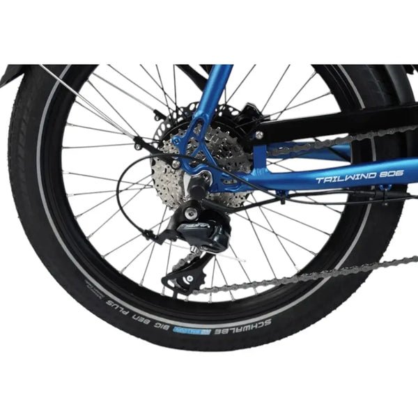 Detailed view of the rear wheel, gear cassette, and derailleur on the Wisper Tailwind 806 Encore Folding E-Bike in blue, highlighting the drivetrain components