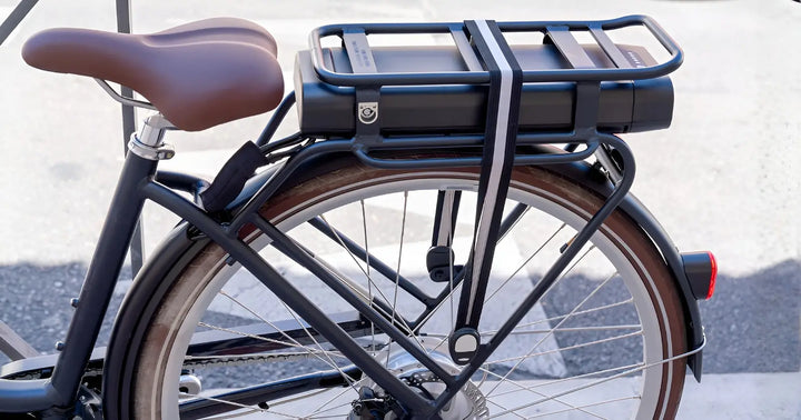 Electric bike with rear rack mounted battery pack secured above the back wheel.