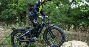 A rider using a fat tyre electric bike on a woodland trail, demonstrating eco-friendly off-road cycling.