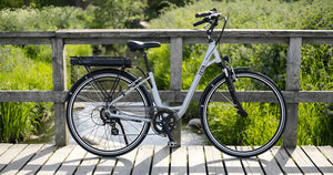 Batribike Zeta step-through electric bike parked on a wooden bridge.
