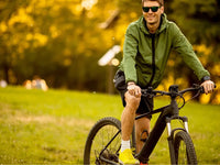 Rider on an electric bike in a park - choosing the right size e-bike for your height