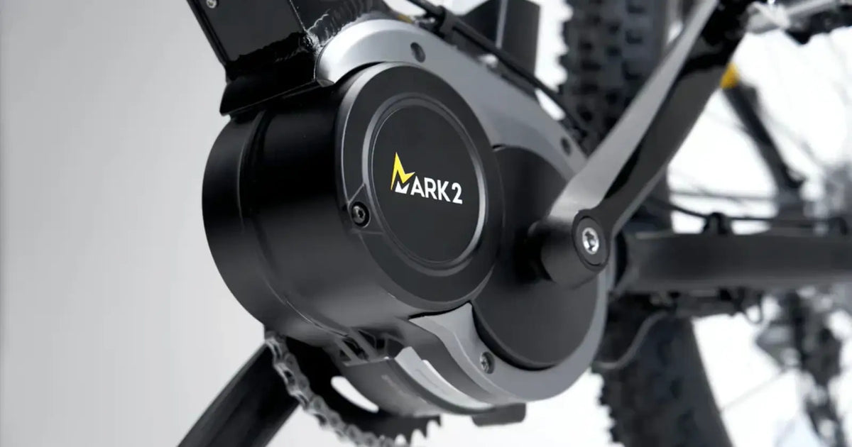 Close-up of a mid-drive motor mounted at the crank area of an electric bike drivetrain.