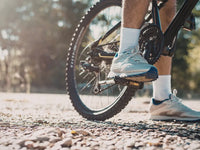 Rider pedalling an electric bike on a gravel path showing pedal assist in action