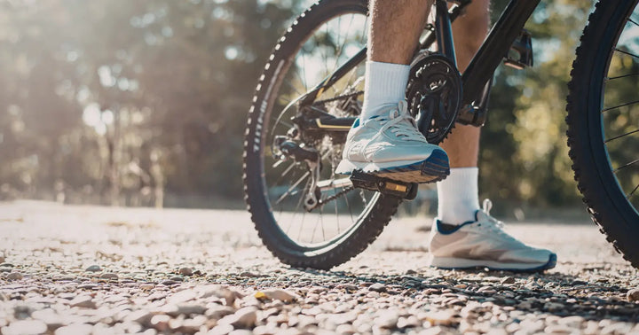 Rider pedalling an electric bike on a gravel path showing pedal assist in action