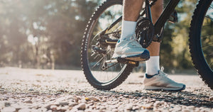 A rider pedalling an electric bike on a gravel path, illustrating how pedal assistance works while cycling.