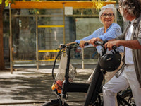 Senior couple riding step-through electric bikes, a joint-friendly option for bad knees and arthritis