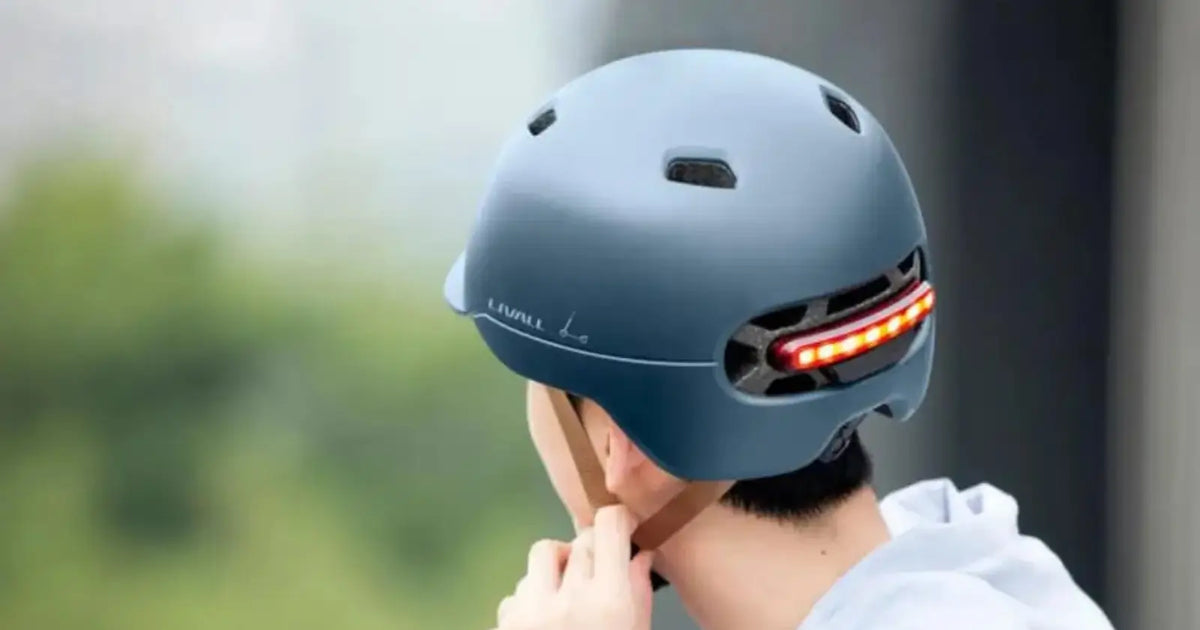 Livall smart cycling helmet with integrated rear LED light for improved visibility and safety while riding an electric bike.