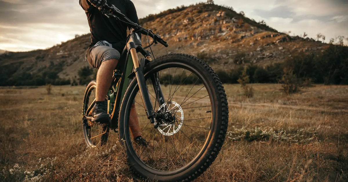 Rider using an electric mountain bike on rugged terrain, highlighting top e-bike performance suitable for UK off-road riding in 2026.