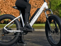 EMovement fat tyre electric bike on a paved path, showing the wide tyres designed for stability and all-terrain riding.