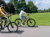 Two riders enjoying a relaxed ride with the Falcon Horizon electric bike, a comfortable hybrid e-bike designed for everyday leisure and commuting.