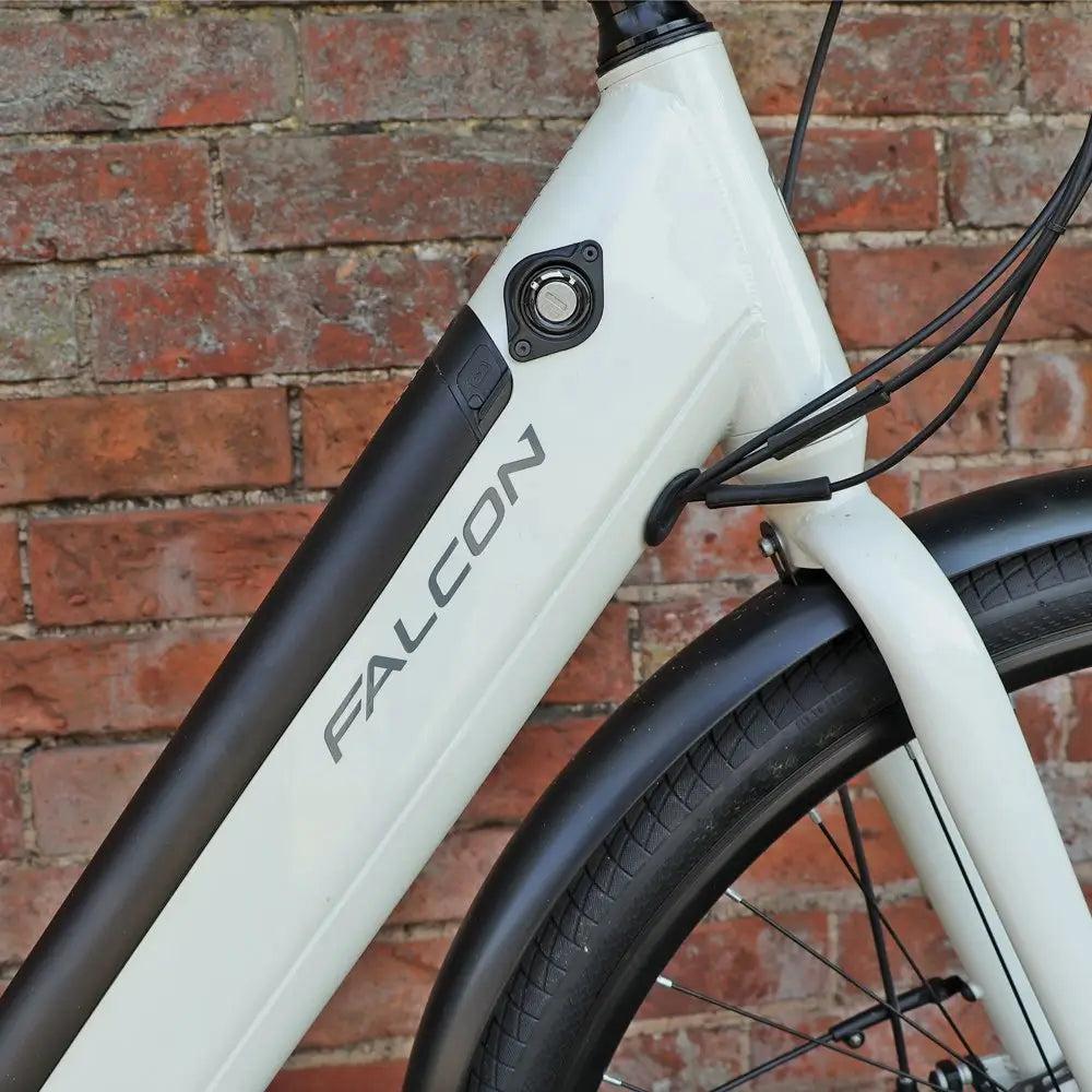 Falcon Liberty electric bike frame detail showing integrated battery and lock system on down tube near front wheel.
