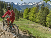 Woman riding an electric mountain bike on a sunny trail