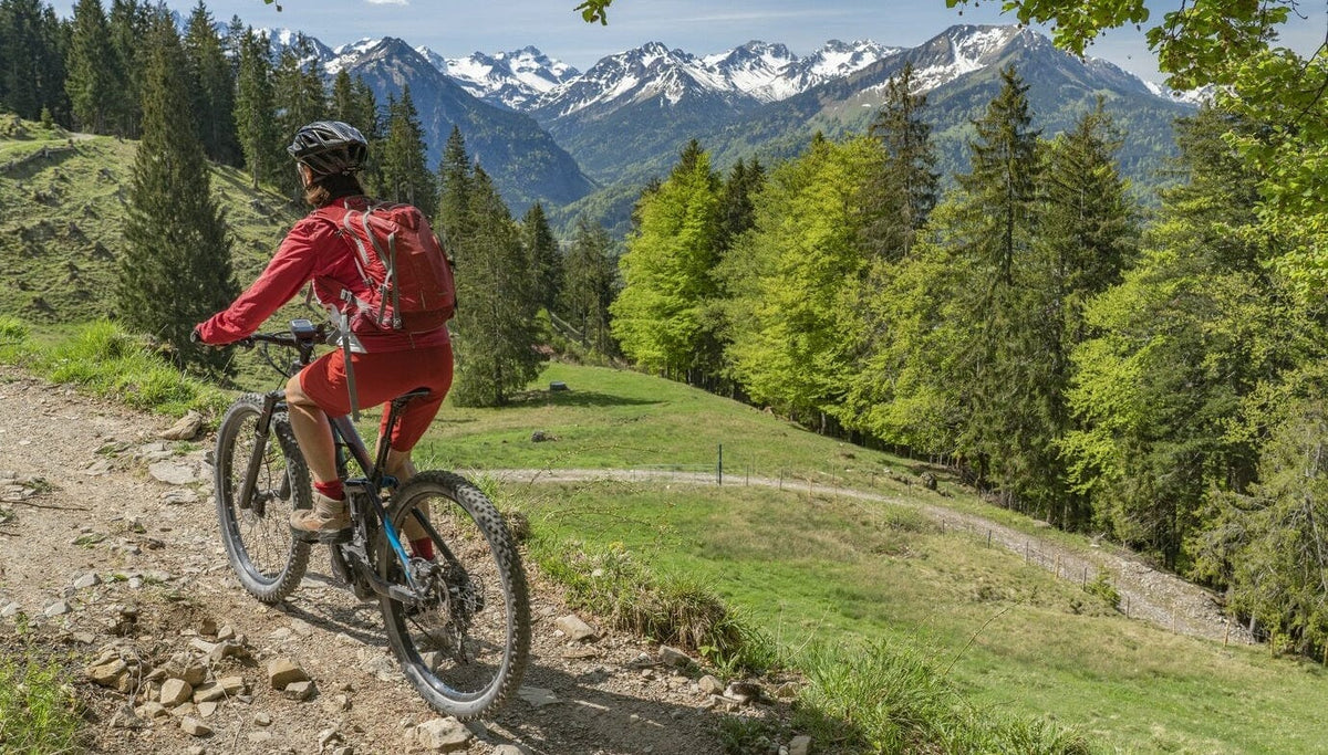 Woman riding an electric mountain bike on a sunny trail