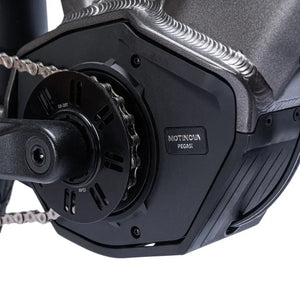 Close-up of mid-drive electric bike motor and crank system integrated into the frame