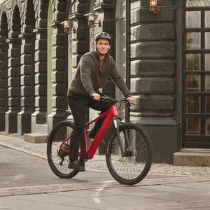 Man with a helmet riding a Batribike pedal assist electric bike in a Danish city