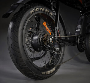 Rocket electric chopper-style electric bike rear wheel with a back studio background.