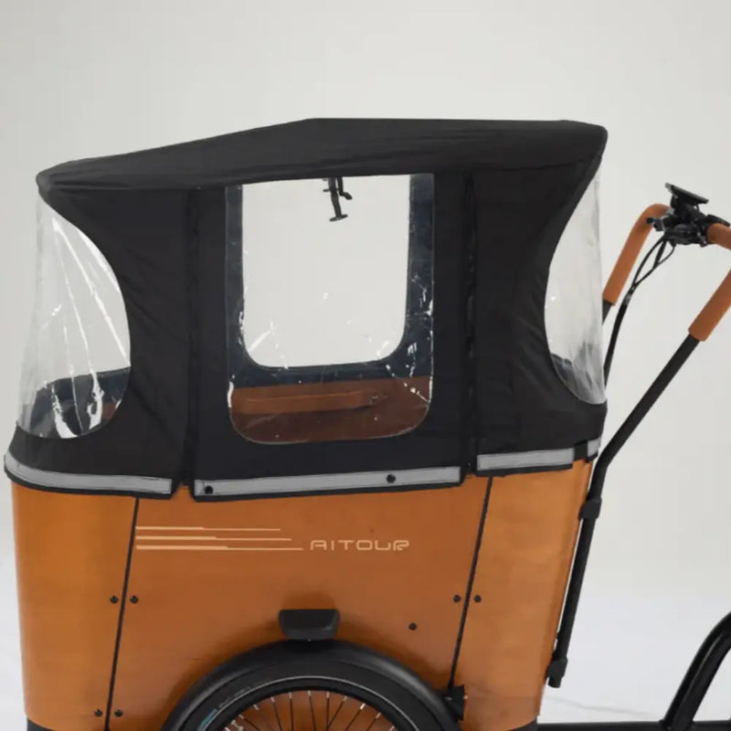 Side view of the Aitour Family C electric cargo trike with the black rain canopy fully installed, illustrating the full enclosure for passenger protection.