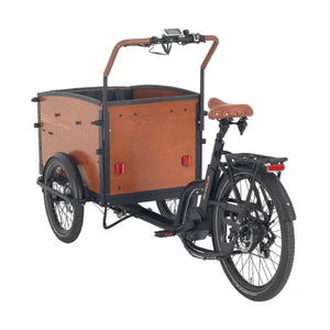 Rear three-quarter view of the Aitour Family S, highlighting the stable three-wheel design, leather saddle, and spacious wooden transport box.