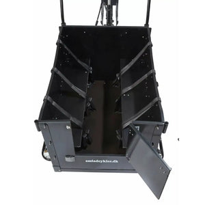 Interior view of the Amcargobikes Kindergarten cargo box showing bench seating with safety belts for four children and an open front access door.