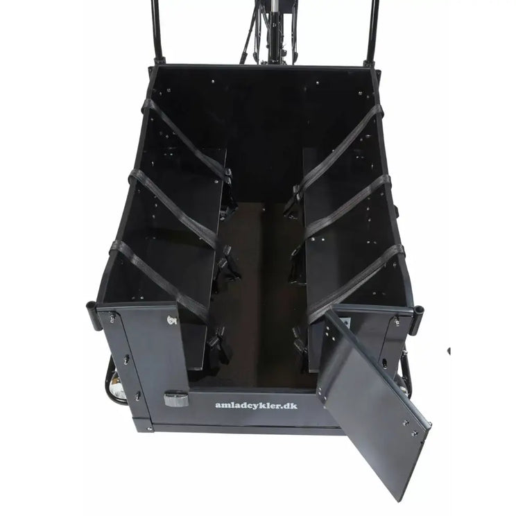 Interior view of the Amcargobikes Kindergarten cargo box showing bench seating with safety belts for four children and an open front access door.