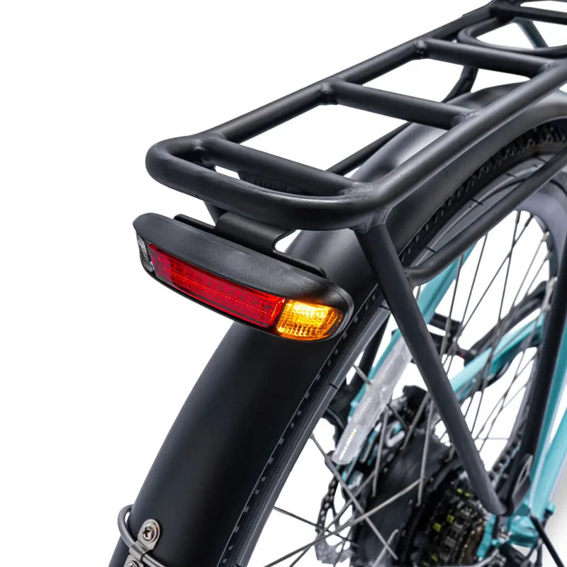 Close-up of the rear luggage rack and integrated safety tail light on the Ampere Deluxe electric bike.