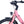 Close-up of the Ampere Deluxe pink handlebar stem and brake levers with integrated front light below.