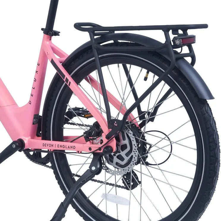 Close-up of the Ampere Deluxe pink rear wheel showing disc brake pannier rack mudguard and Devon England chainstay.