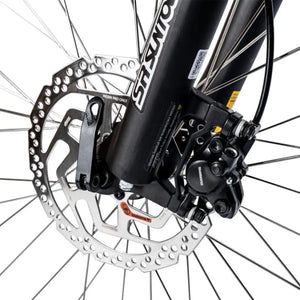 Close-up of the Shimano hydraulic disc brake caliper mounted on the SR Suntour suspension fork.