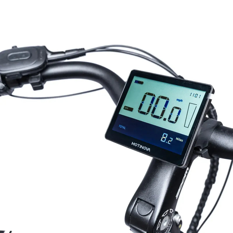 Digital Motinova LCD display on the handlebars showing speed and ride data on the Deluxe Pro e-bike.