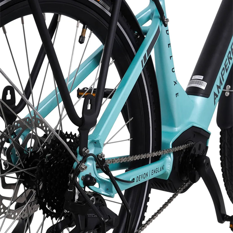 Detail of the rear frame triangle showing the disc brake rotor and Devon England branding on the Ampere Deluxe Pro.