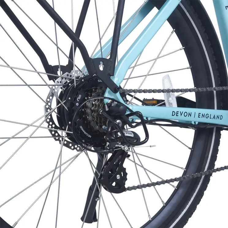 Close-up of the Ampere Deluxe pale blue rear chainstay showing Shimano Altus derailleur disc brake and Devon England branding.