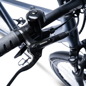 Close-up of the handlebar bell and Shimano brake lever on the Ampere Hilux electric bike.