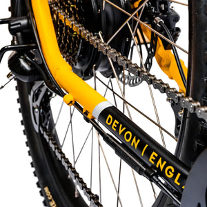 Close-up of the "Devon England" origin text on the yellow chainstay of the Ampere X-Trail.