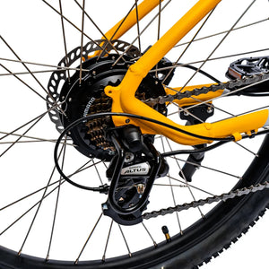 Rear hub motor and yellow dropout detail on the Ampere X-Trail electric mountain bike.