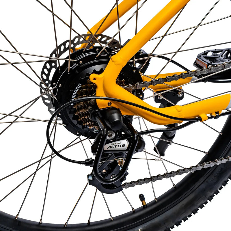 Rear hub motor and yellow dropout detail on the Ampere X-Trail electric mountain bike.