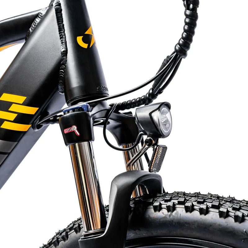 Front suspension fork crown and LED headlight detail on the Ampere X-Trail.
