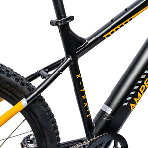 Close-up of the yellow Ampere logo branding on the black downtube of the X-Trail.