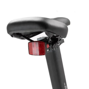Padded saddle of the Axon Rides Pro Folding Electric Bike 250W with mounted rear safety reflector.