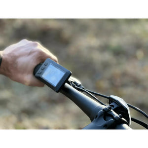 Close-up of the digital handlebar display on the Basis Protocol Electric Hybrid Mountain Bike 250W, showing speed and settings interface.